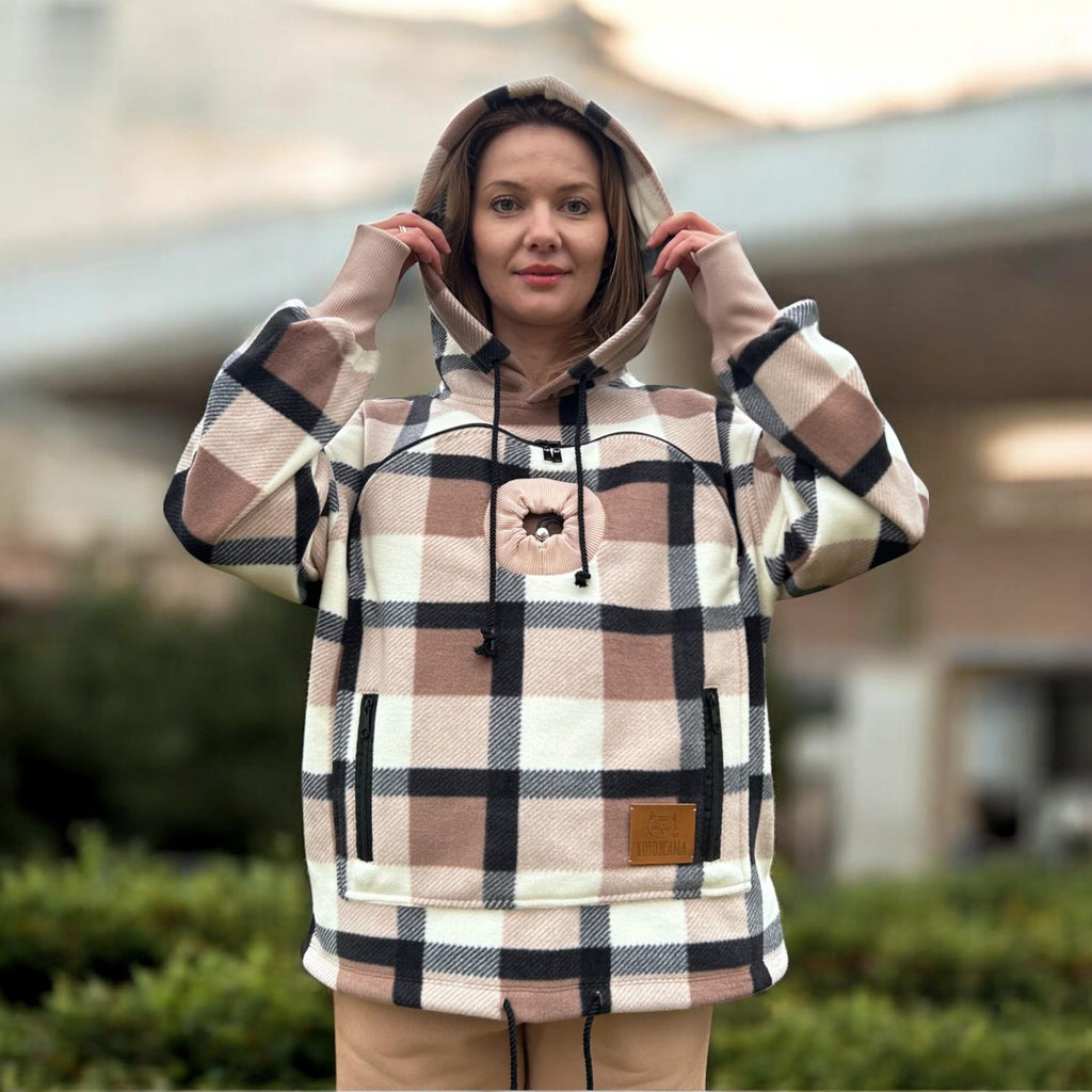 Person wearing a Beige Plaid hoodie with a blurred outdoor background