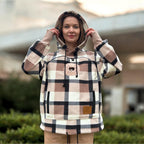 Person wearing a Beige Plaid hoodie with a blurred outdoor background