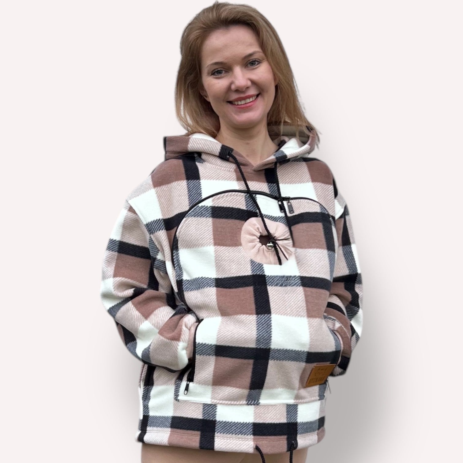 Woman wearing a Beige Plaid hoodie against a plain background