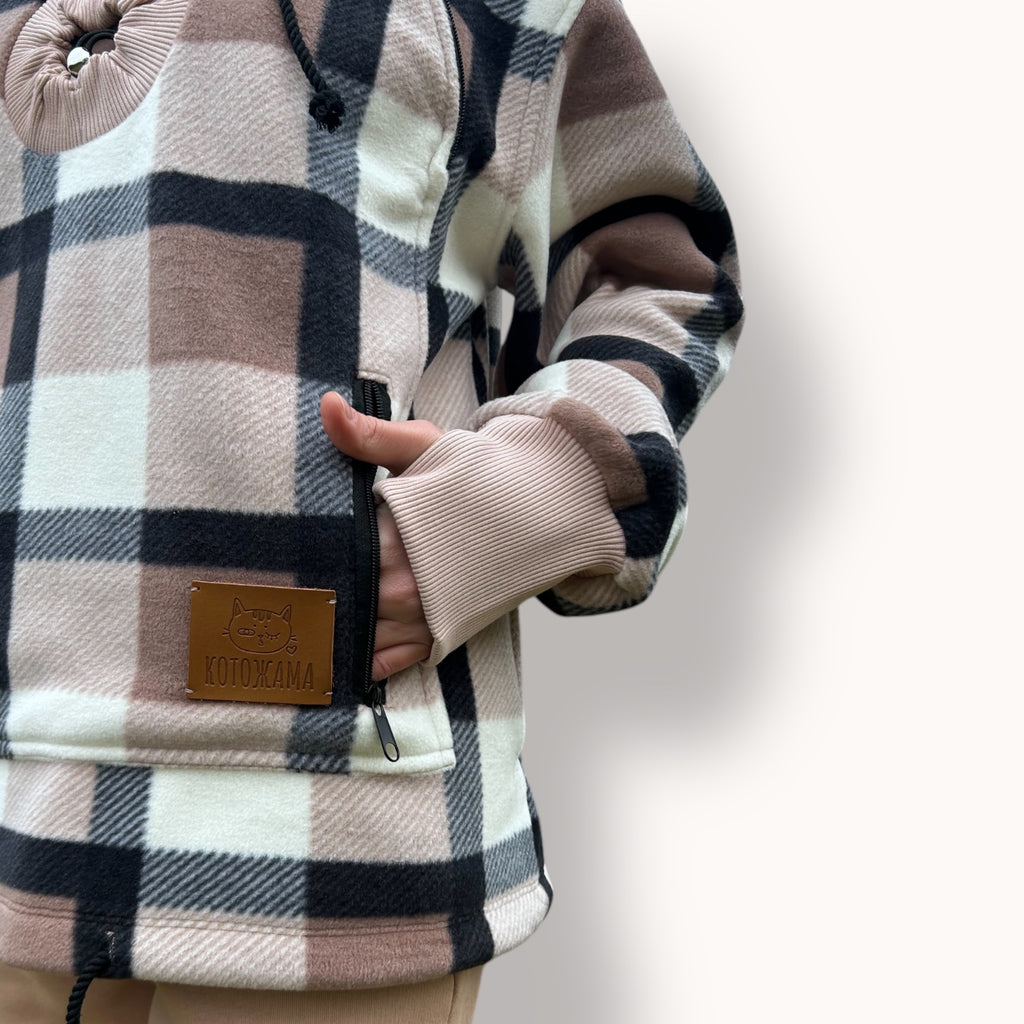 Plaid-patterned coat with a leather patch on a light background