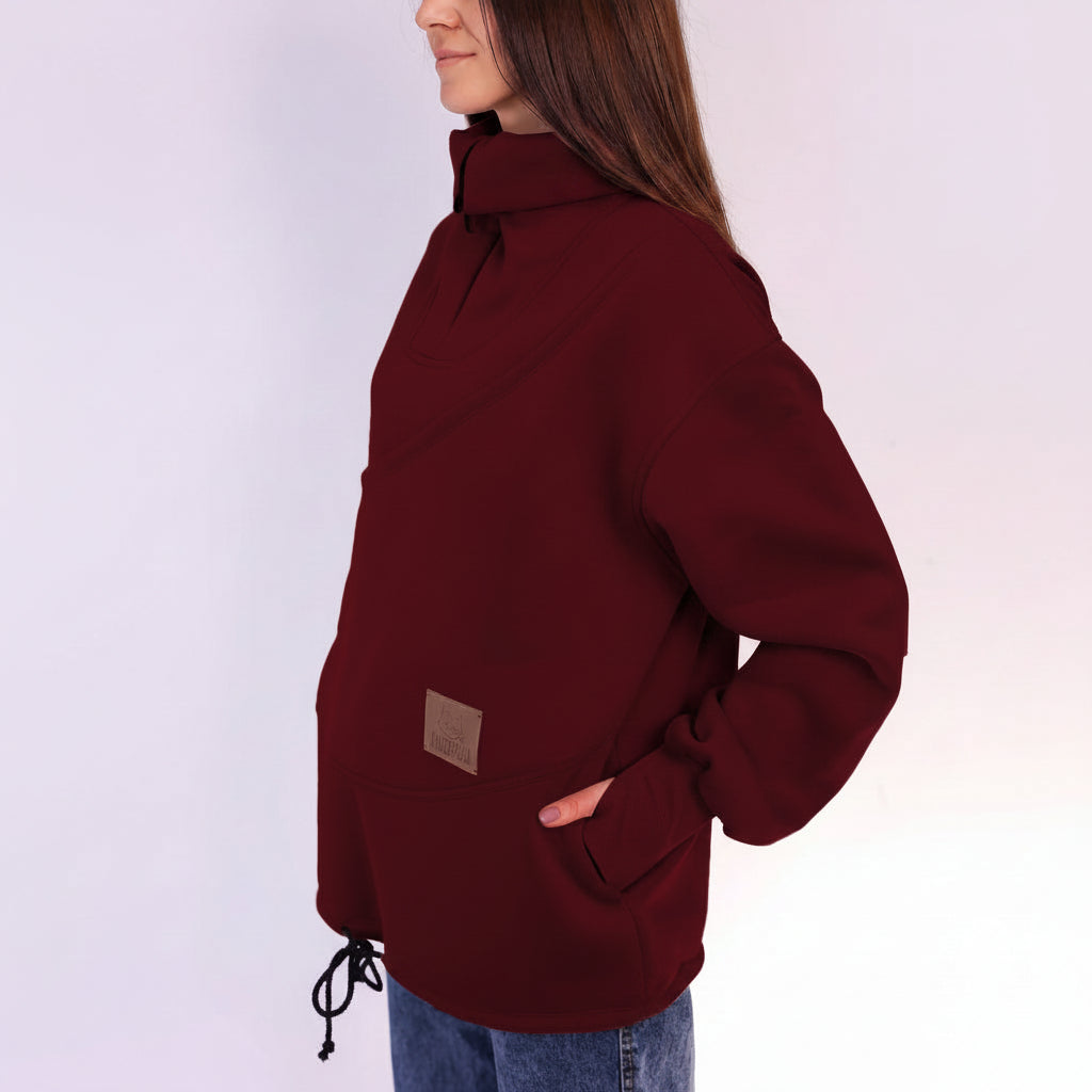 Burgundy fleece pullover worn by a person on a white background