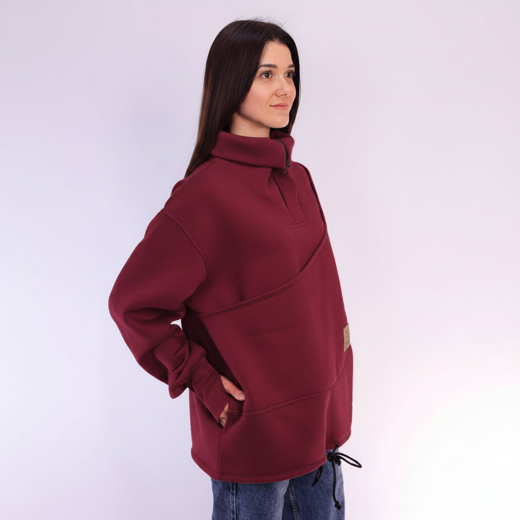 Woman wearing a Burgundy sweater with a white background