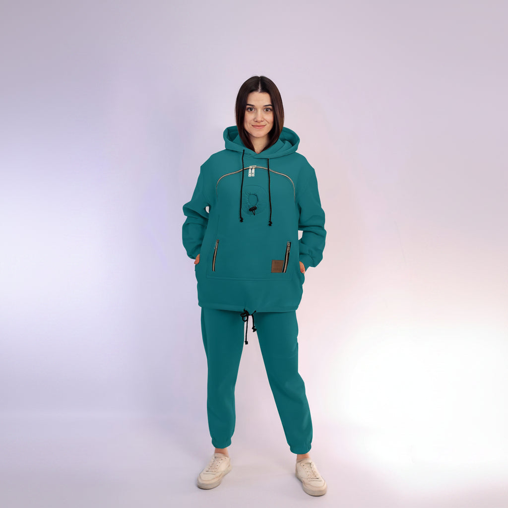 Person wearing a teal tracksuit on a white background