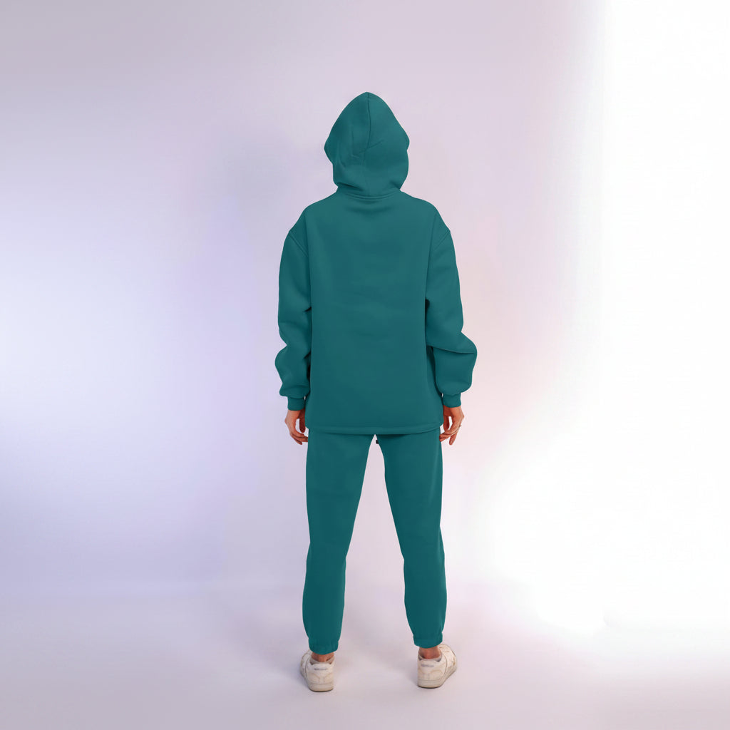 Teal tracksuit worn by a person on a white background
