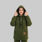 A woman wearing an dark green hooded sweatshirt with black drawstrings and zipper details, posing against a plain light background.
