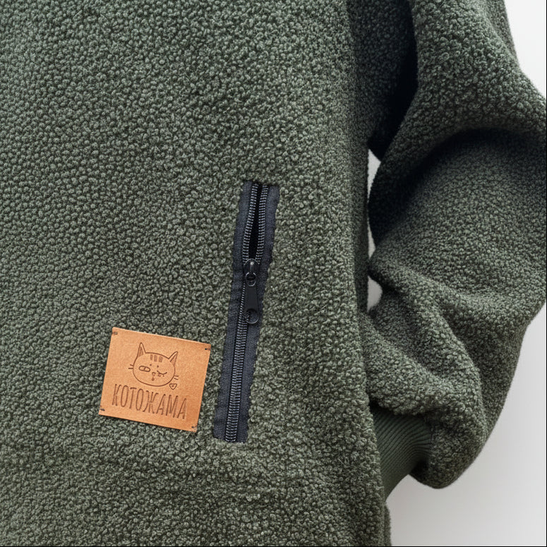 Khaki fleece jacket with a leather patch and zipper, featuring the brand 'Kotozhama'.