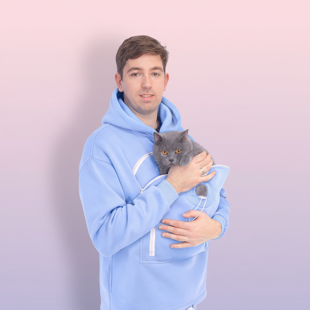 Men wearing a Light Blue hoodie holding a gray cat against a white background