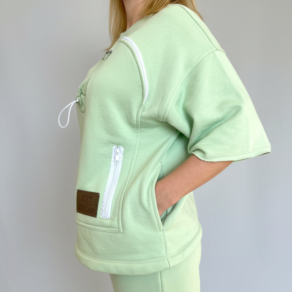 Lime green scrub top worn by a person on a plain background