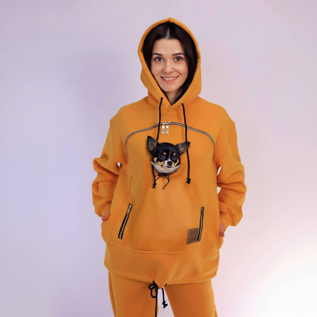 Person wearing an Mustard hoodie with a dog on a white background