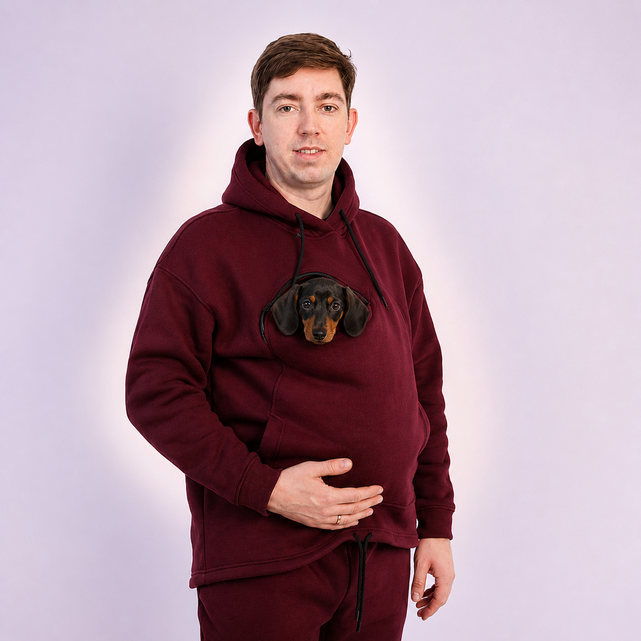 Person wearing a Red Burgundy hoodie with a dachshund face design on a light gray background