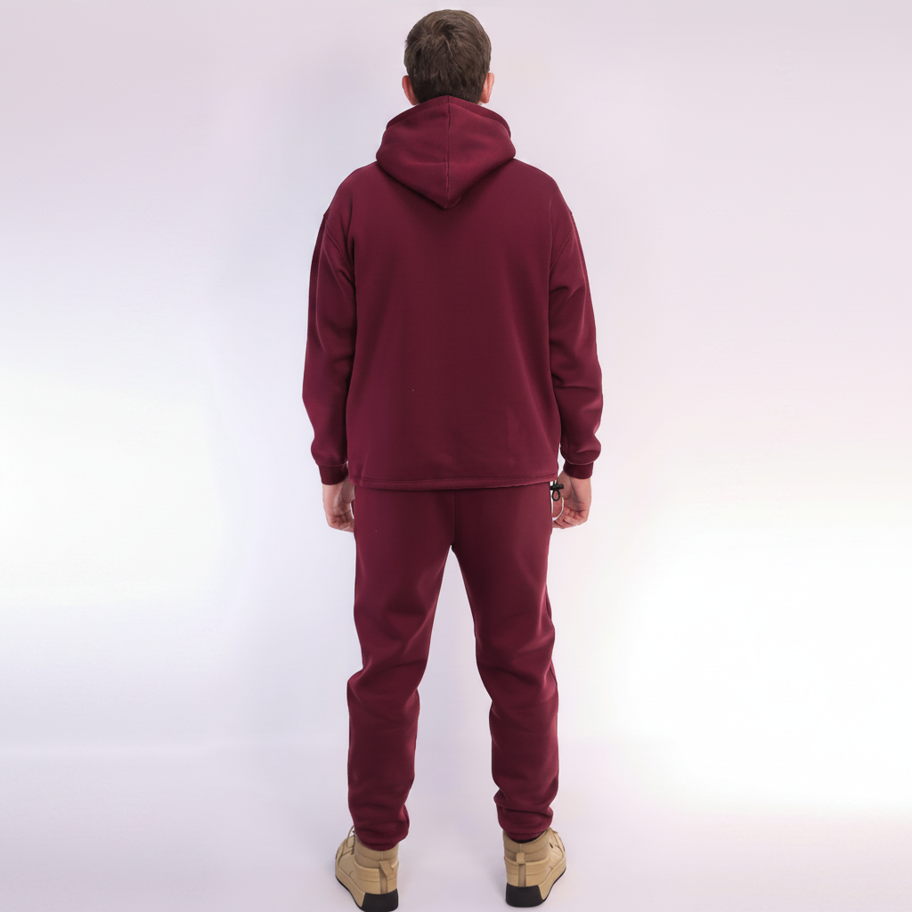 Person wearing a Red Burgundy tracksuit on a white background