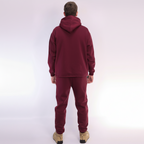 Person wearing a Red Burgundy tracksuit on a white background