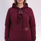 Maroon hoodie with a brown patch on a white background