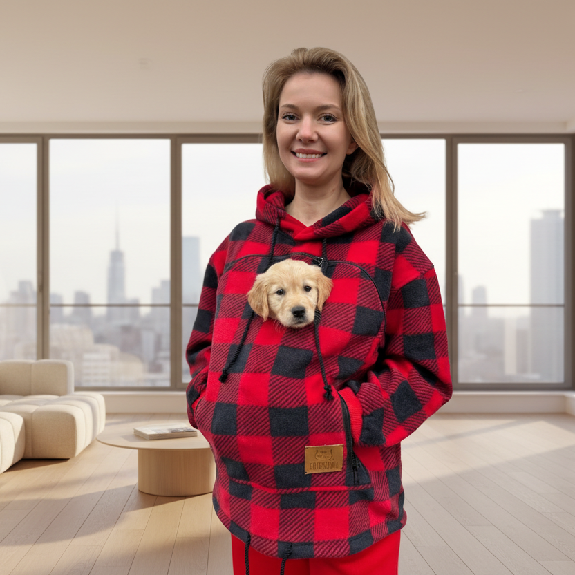 Person wearing a red and black checkered hoodie with a puppy inside, standing against a plain background. Main image