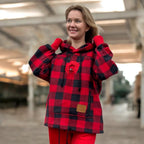 Person wearing a red and black checkered hoodie with a blurred background