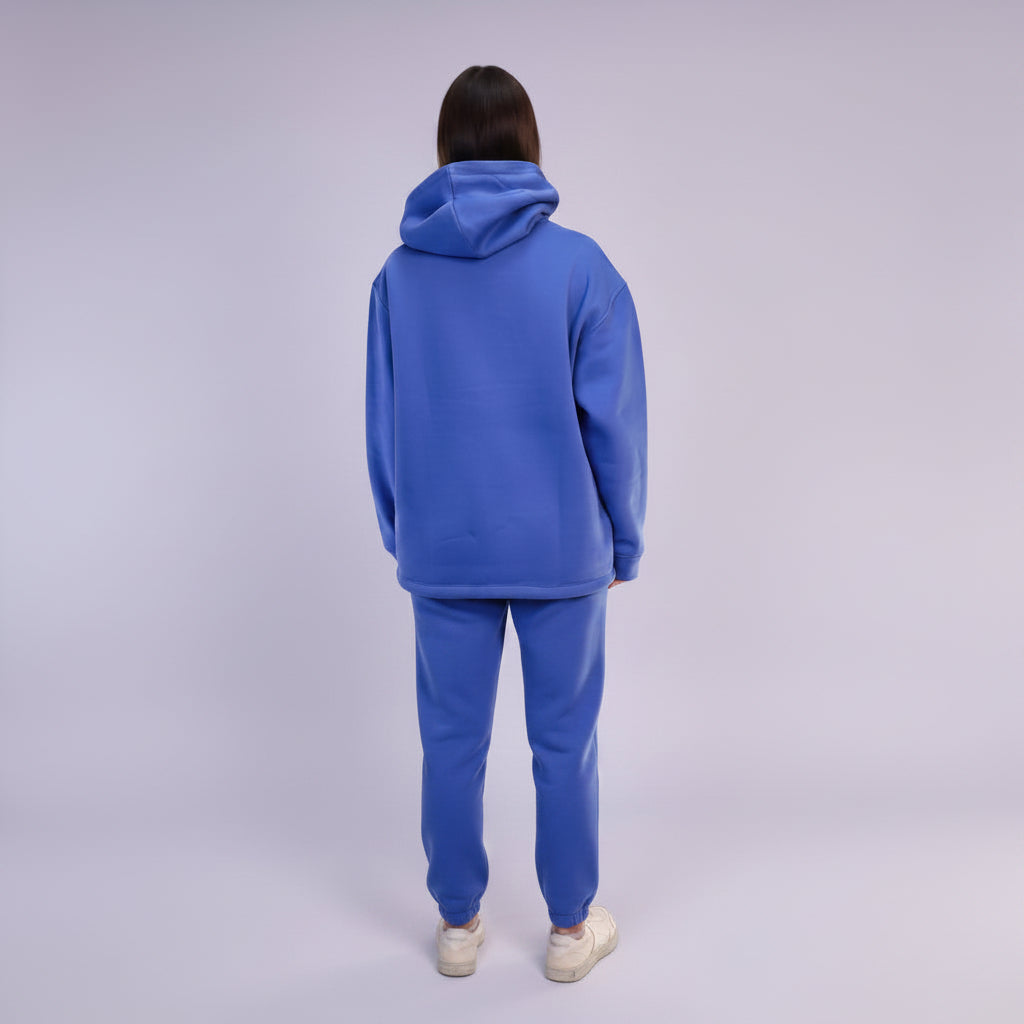 Person wearing a Royal Blue tracksuit on a white background