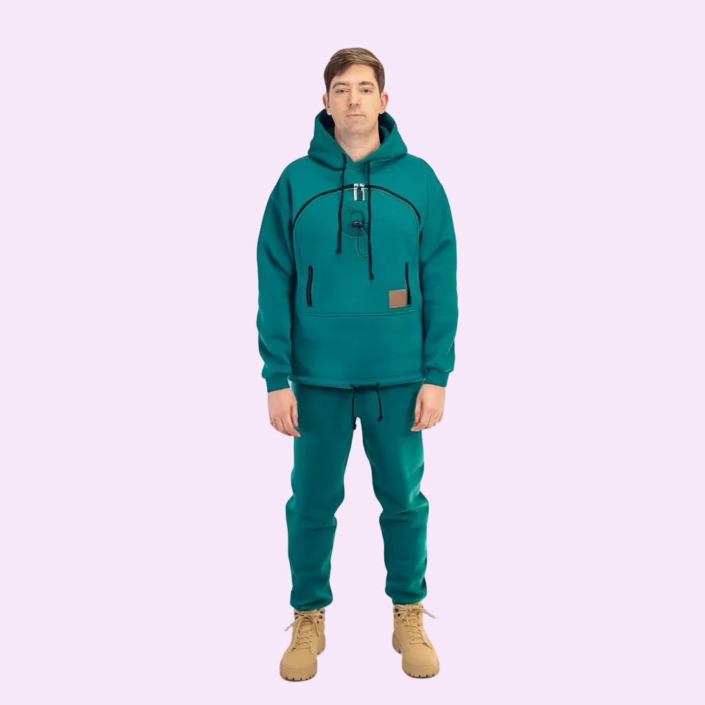 Person wearing a teal hoodie and pants with beige boots on a white background