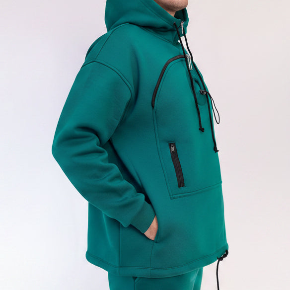 Teal tracksuit with a black zipper pocket on a white background