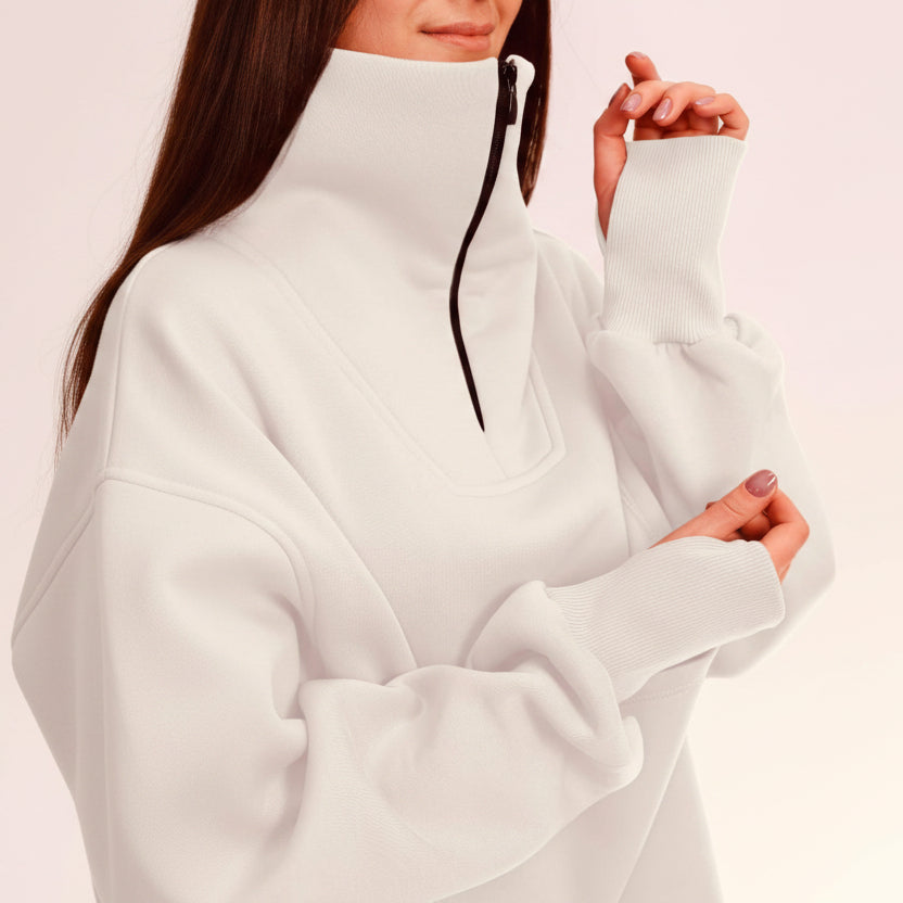 White oversized sweater worn by a person on a light pink background