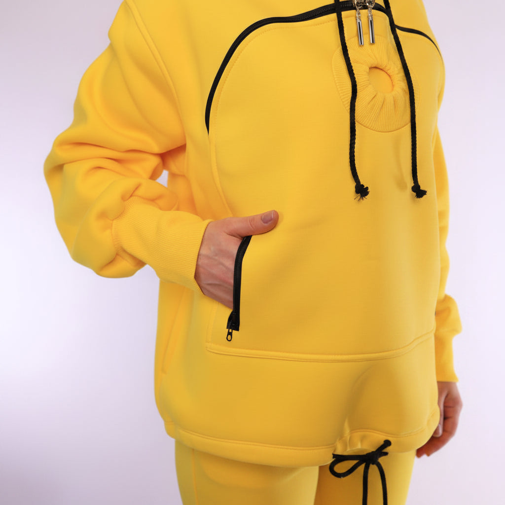 Yellow hoodie with black zipper and drawstring on a white background