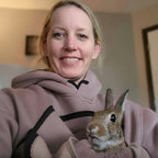 Woman holding a rabbit indoors