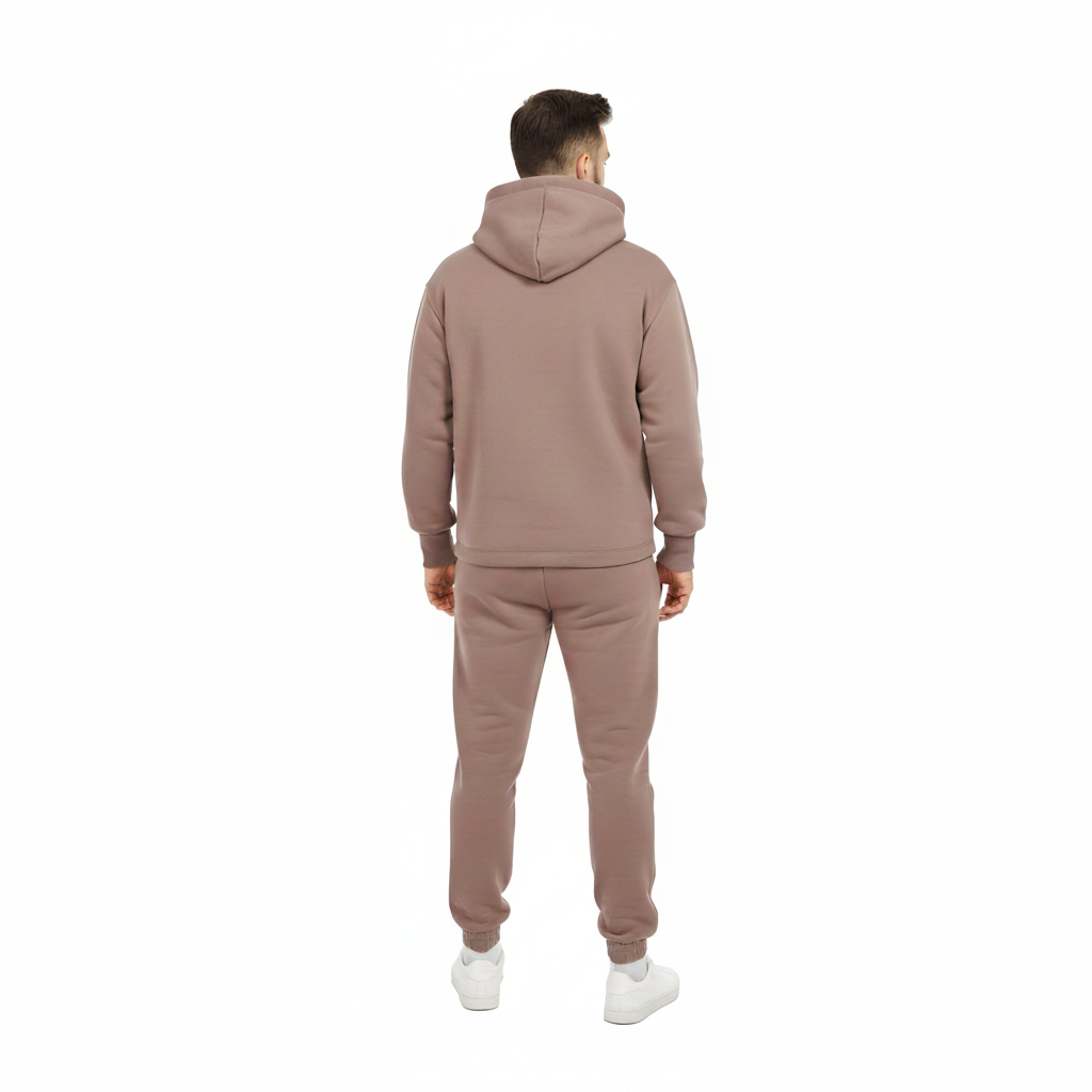 Man wearing a matching brown hoodie and pants set on a white background