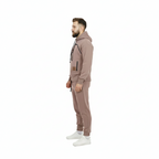 Man wearing a brown tracksuit on a white background