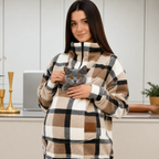 Person wearing a plaid sweatshirt with cat in a pouch