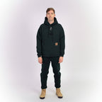 Person wearing a black hoodie and pants on a white background