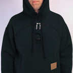 Black hoodie with a brown patch on a white background