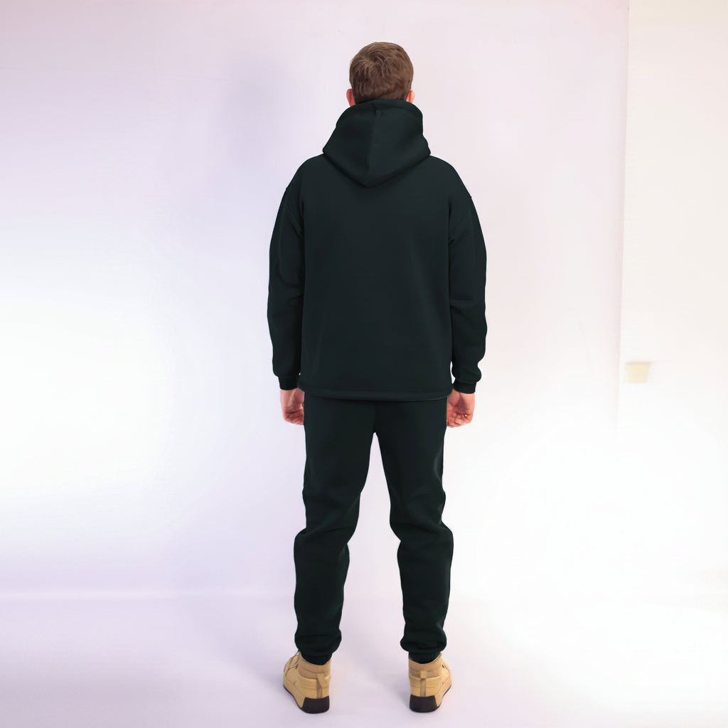 Person wearing a black hoodie and pants on a white background