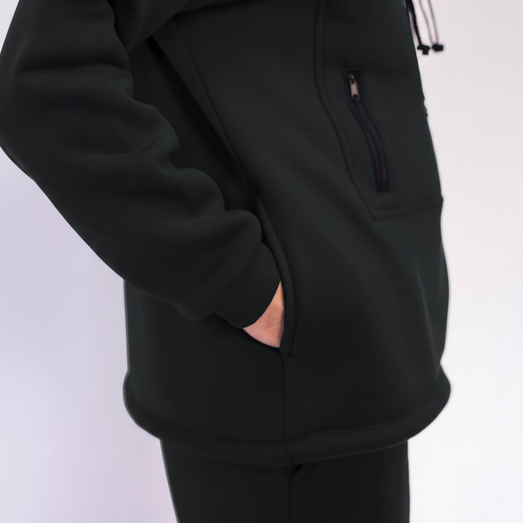 Close-up of a black hoodie with a pocket on a white background
