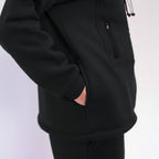 Close-up of a black hoodie with a pocket on a white background