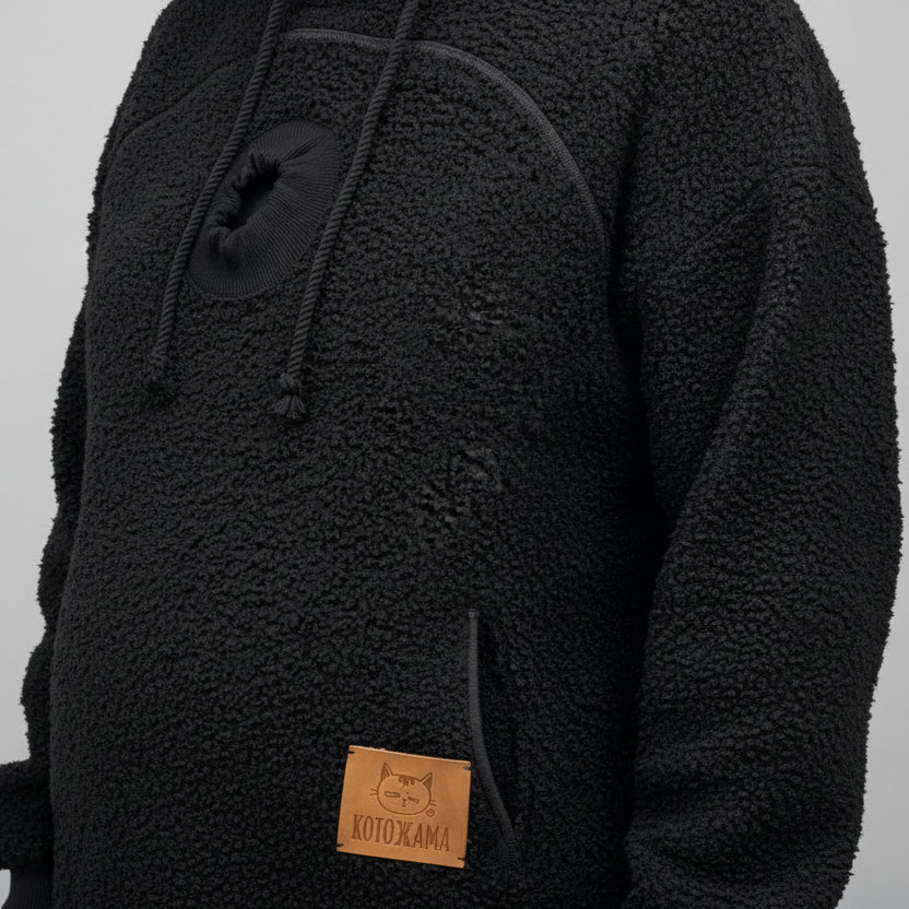 Black boucle fleece hoodie with a brand label