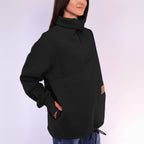 Person wearing a black sweatshirt with cut-out details on a white background