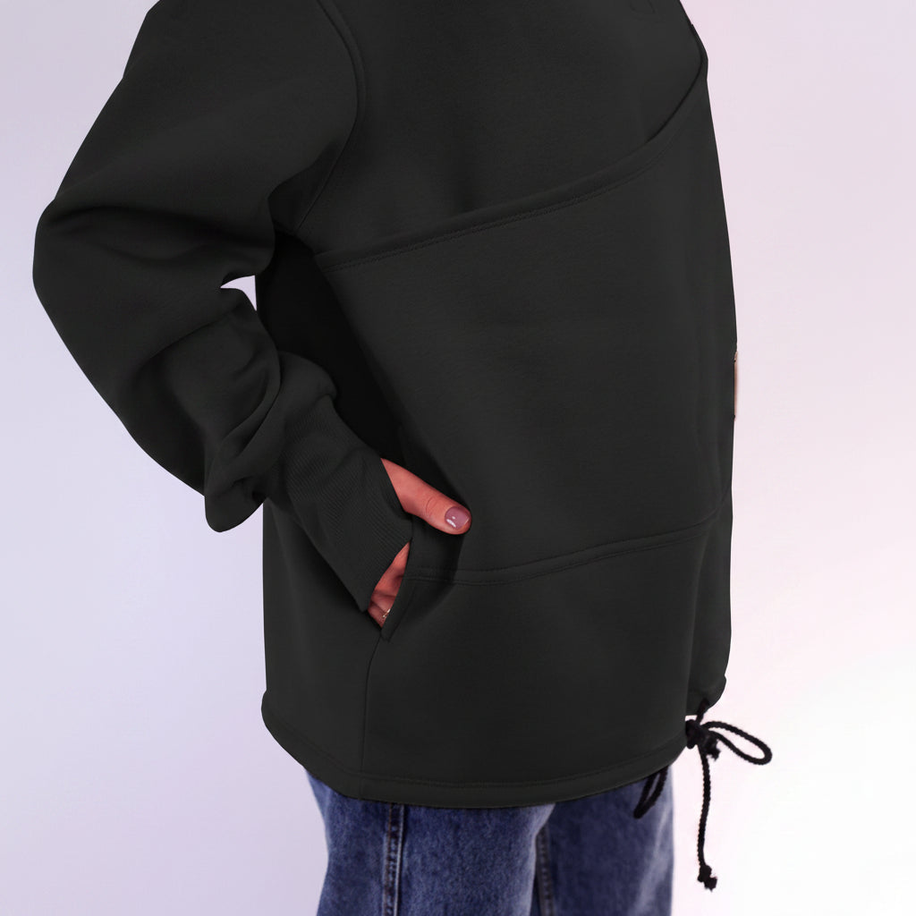 Black sweatshirt with a front pocket on a light purple background