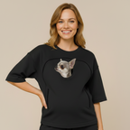 Woman wearing a black sweatshirt with a dog's pocket on a beige background