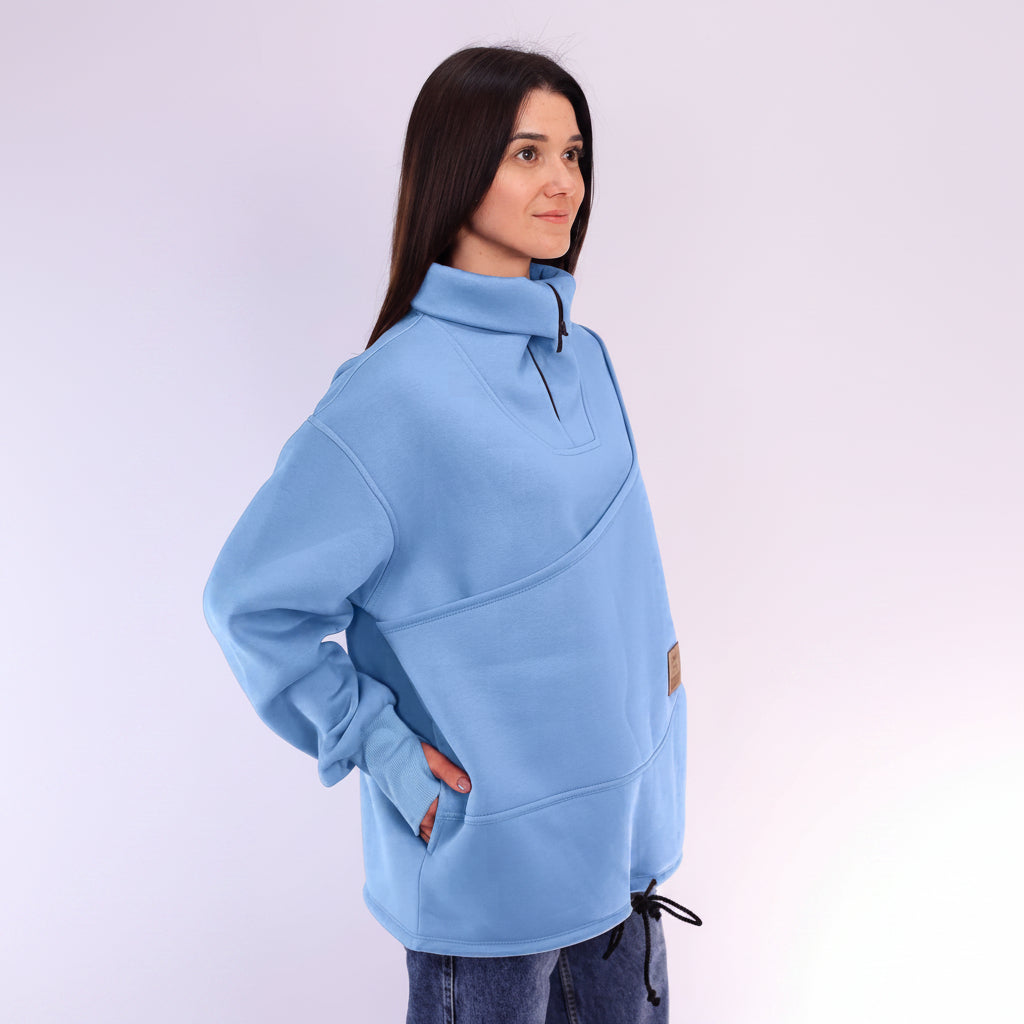 Woman wearing a light blue fleece pullover on a white background
