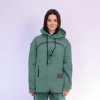 Person wearing a emerald  hoodie with a plain background