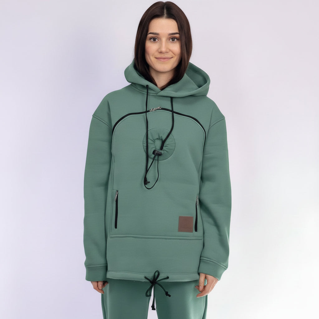 Person wearing a emerald  hoodie and pants set on a white background