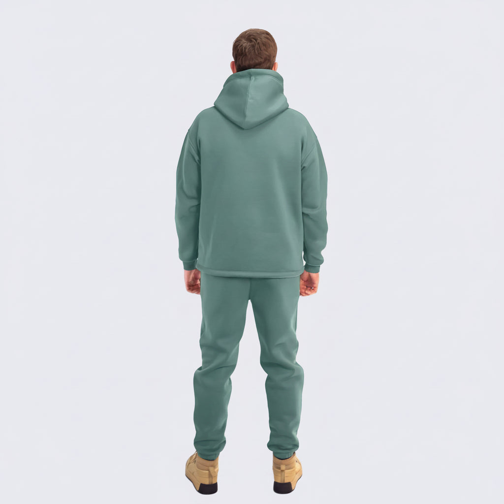 Person wearing a emerald tracksuit on a white background