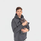 Person wearing a gray hoodie with a cat inside, on a white background