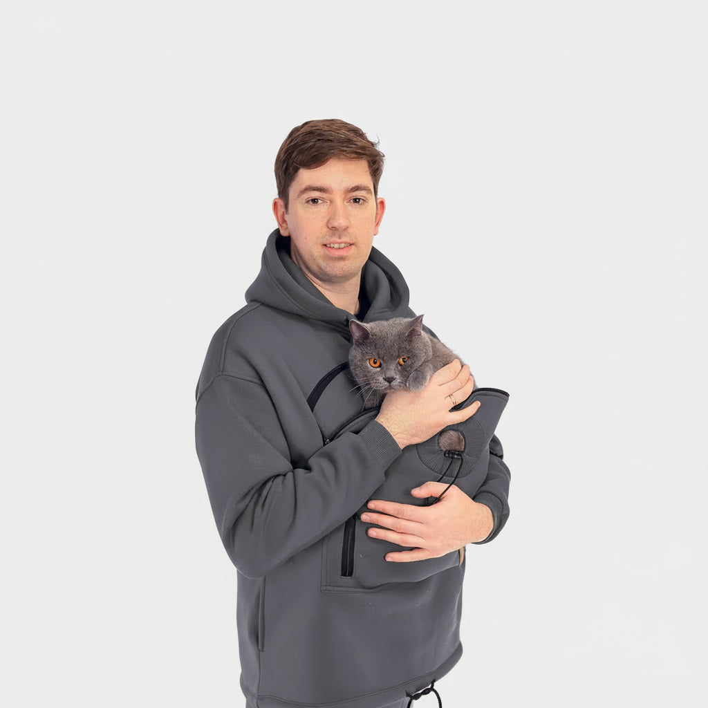 Person wearing a gray hoodie with a cat inside, on a white background