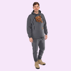 Person wearing a gray hoodie with a pocket containing a small dog, standing against a white background