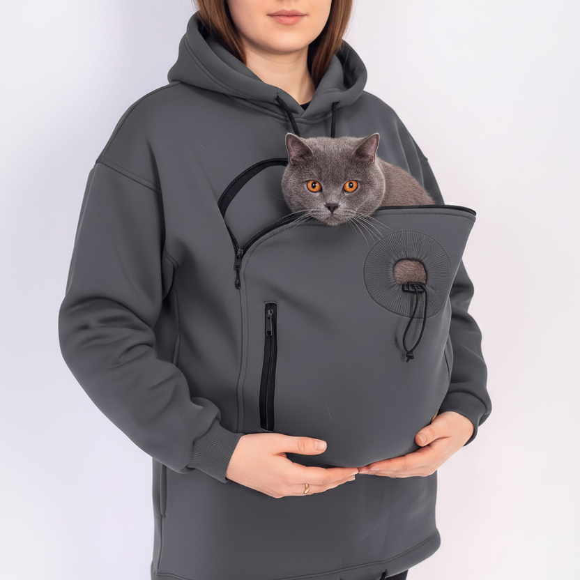 Women wearing a gray hoodie with a front pocket containing a cat on a white background