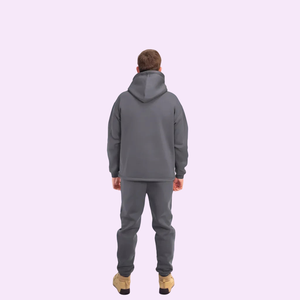 Person wearing a gray tracksuit on a white background