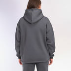 Person wearing a gray hoodie on a white background