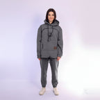 Women wearing a gray hoodie and pants set on a white background