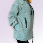 Green fleece hoodie with a zipper on a white background