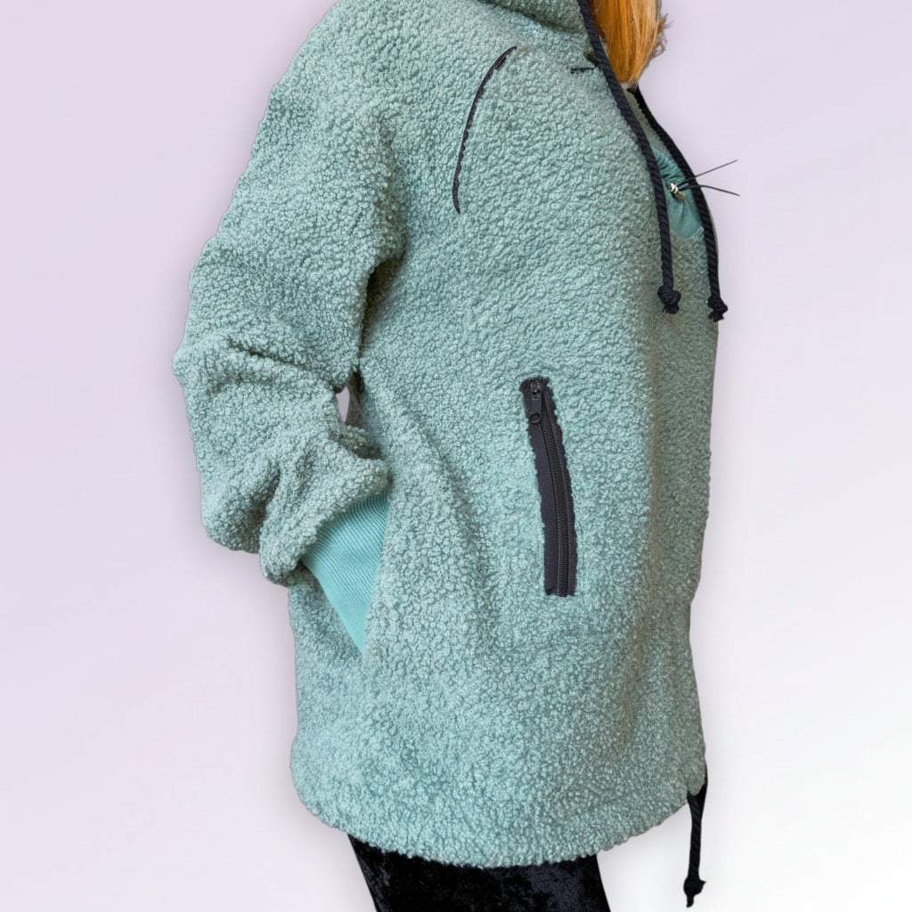 Green fleece hoodie with a zipper on a white background